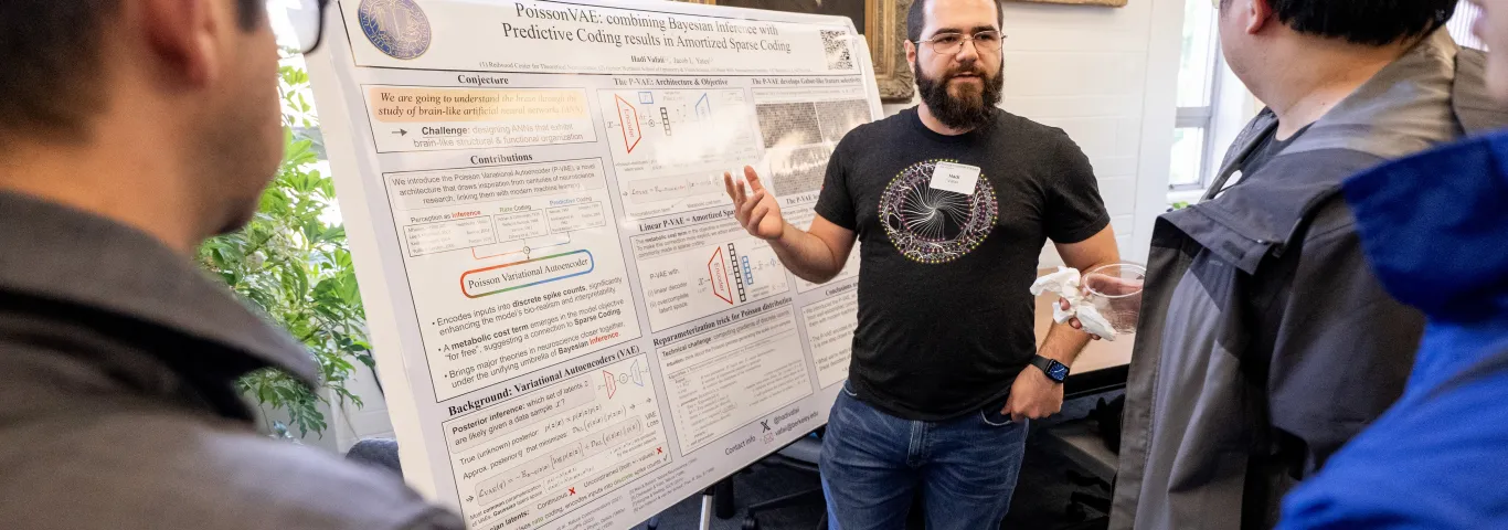"person presenting his research at a poster session"
