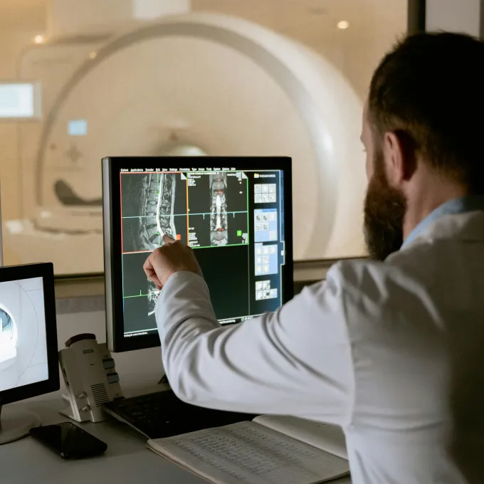 "a man reviewing data on his computer within a lab setting"